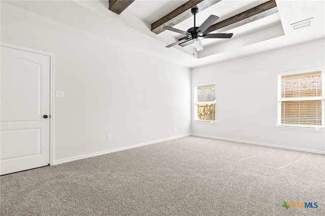 unfurnished room featuring carpet, a raised ceiling, ceiling fan, and beamed ceiling