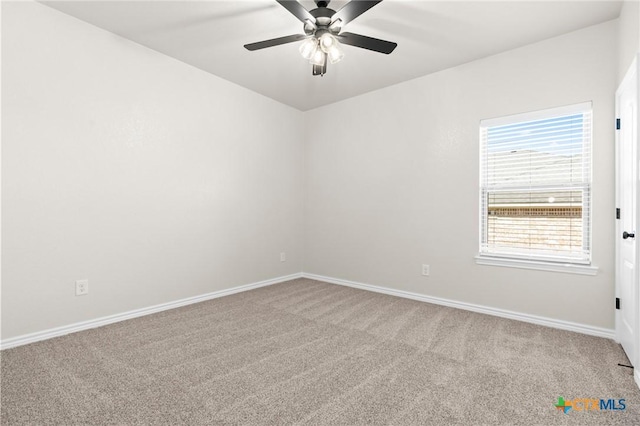 carpeted spare room featuring ceiling fan