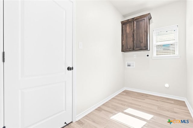 laundry room featuring hookup for an electric dryer, washer hookup, light wood-type flooring, and cabinets