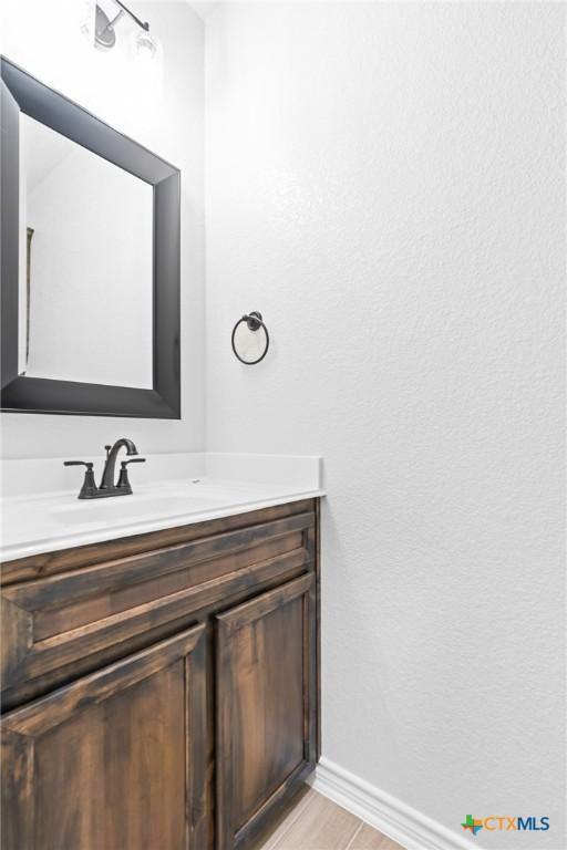 bathroom featuring vanity and hardwood / wood-style flooring