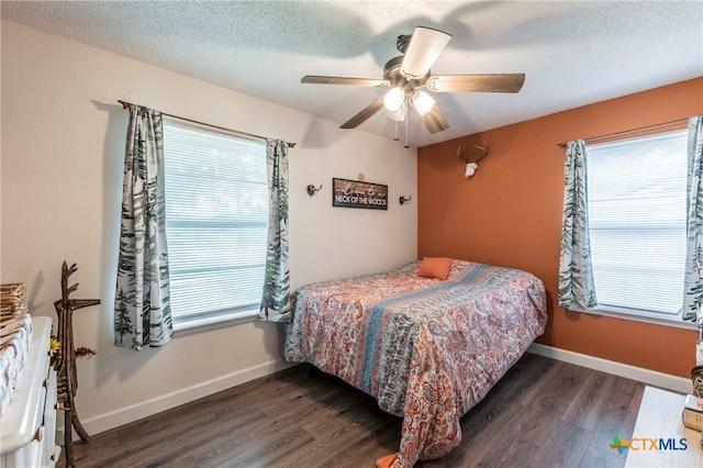 bedroom featuring a textured ceiling, dark hardwood / wood-style flooring, and ceiling fan