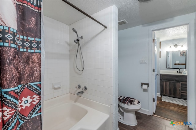 full bathroom with a textured ceiling, shower / bath combo with shower curtain, wood-type flooring, vanity, and toilet