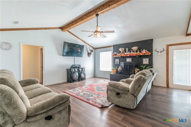 living room featuring a brick fireplace, wood-type flooring, vaulted ceiling with beams, and ceiling fan