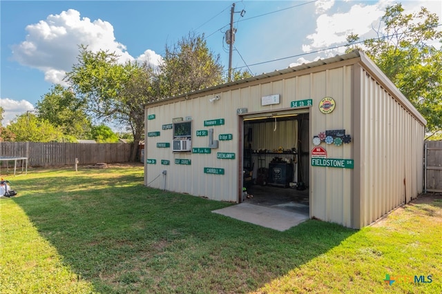 view of outdoor structure featuring a yard and cooling unit