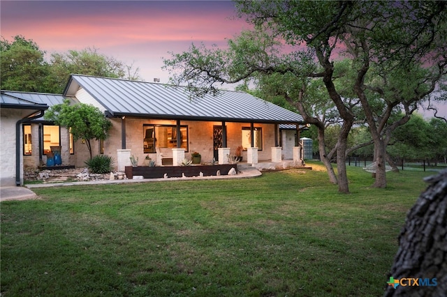 1910 S Rainbow Ranch Rd, Wimberley, TX 78676 - rear view of house featuring a standing seam roof, a porch, metal roof, and a yard
