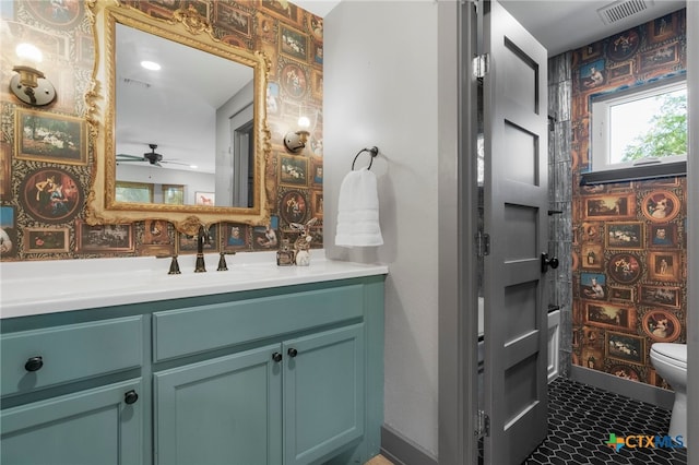 1910 S Rainbow Ranch Rd, Wimberley, TX 78676 - full bathroom with toilet, vanity, a ceiling fan, and shower / bathtub combination