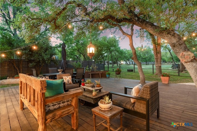 1910 S Rainbow Ranch Rd, Wimberley, TX 78676 - wooden deck featuring a fenced backyard, outdoor dining space, and an outdoor living space