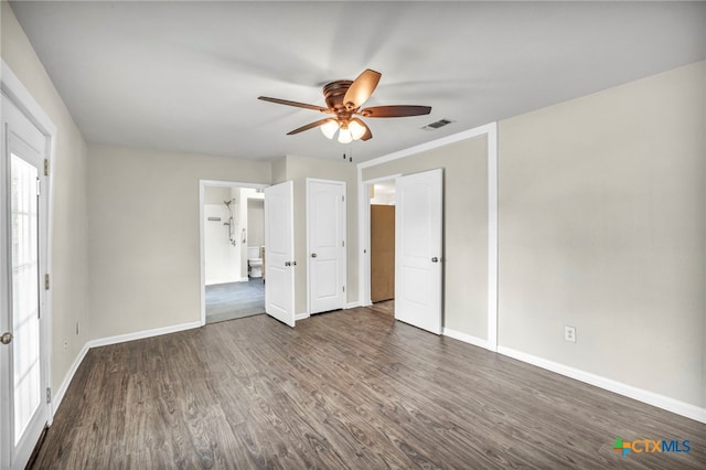 empty room featuring dark hardwood / wood-style flooring and ceiling fan