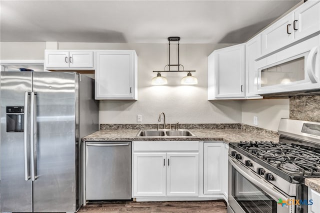 kitchen featuring white cabinetry, sink, and stainless steel appliances