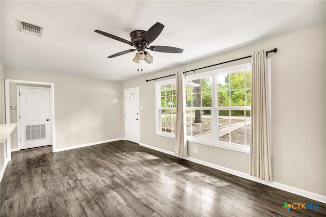 empty room featuring dark hardwood / wood-style floors and ceiling fan