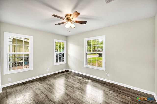 unfurnished room featuring dark wood-type flooring and ceiling fan