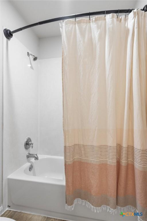 full bathroom featuring shower / bathtub combination with curtain