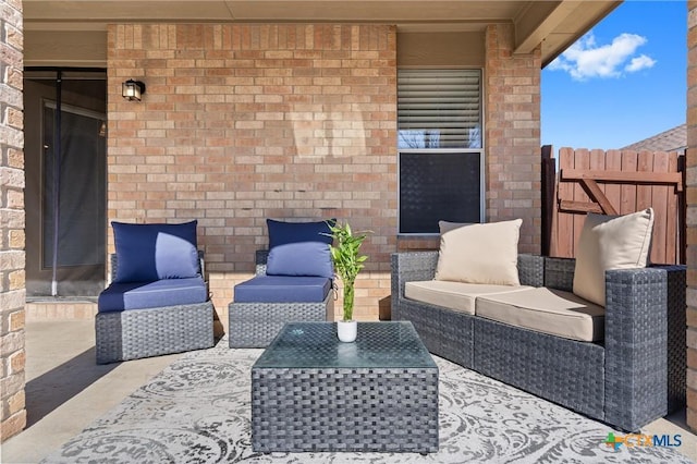 view of patio featuring outdoor lounge area and fence