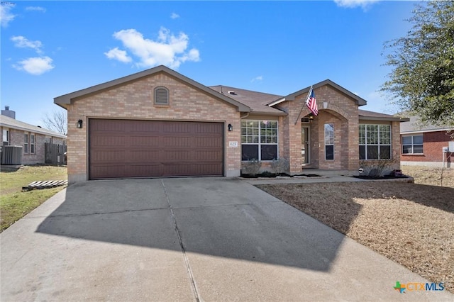 ranch-style home featuring a garage, driveway, brick siding, and cooling unit