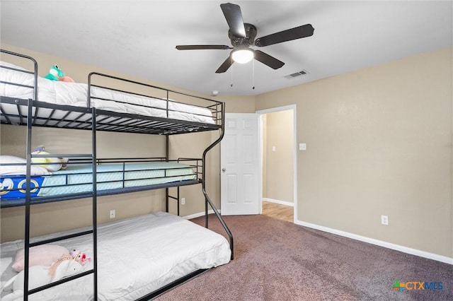 carpeted bedroom featuring baseboards and visible vents