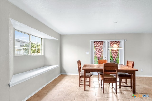 dining area with plenty of natural light and light tile patterned floors