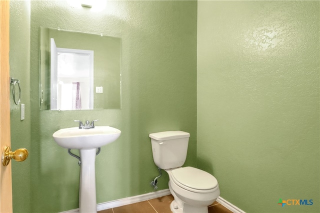 bathroom with tile patterned floors, toilet, and sink