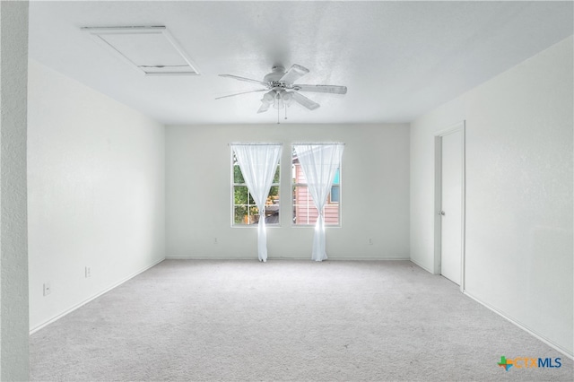 empty room featuring ceiling fan and light colored carpet