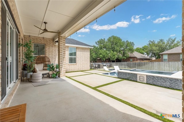 view of patio / terrace with ceiling fan, a fenced backyard, and a fenced in pool