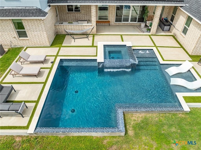 view of pool with a grill, a patio, and an in ground hot tub