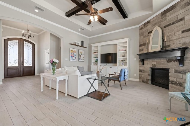 1745 Alta Vista Loop, Temple, TX 76502 - living room with light wood-type flooring, french doors, ceiling fan with notable chandelier, arched walkways, and visible vents