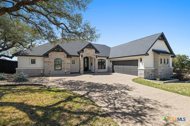 1745 Alta Vista Loop, Temple, TX 76502 - french country style house featuring concrete driveway, stucco siding, stone siding, a garage, and a shingled roof