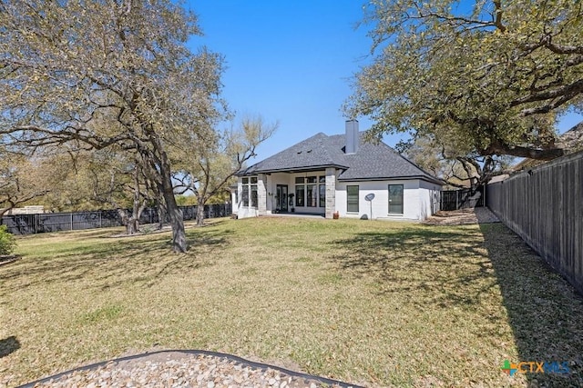 1745 Alta Vista Loop, Temple, TX 76502 - back of property with a lawn, a chimney, a fenced backyard, and roof with shingles