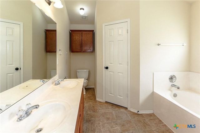 full bath featuring a bath, a sink, and toilet