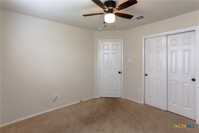 unfurnished bedroom with a closet, visible vents, carpet flooring, ceiling fan, and baseboards