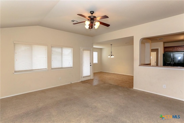 unfurnished living room featuring ceiling fan, visible vents, vaulted ceiling, and carpet flooring