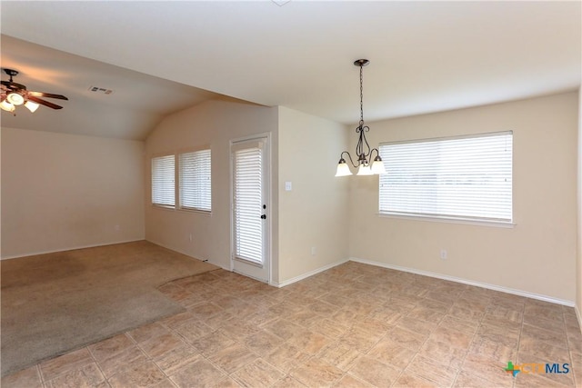 spare room with a healthy amount of sunlight, light carpet, visible vents, and vaulted ceiling