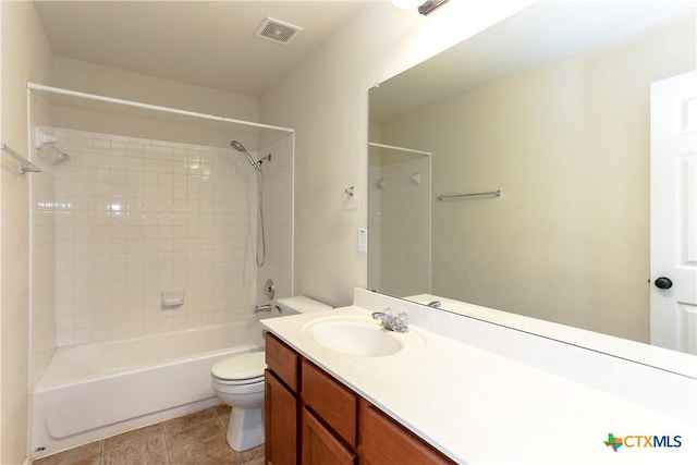 bathroom featuring toilet, vanity, visible vents,  shower combination, and tile patterned floors