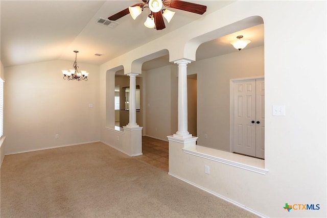 unfurnished room featuring carpet, decorative columns, visible vents, vaulted ceiling, and ceiling fan