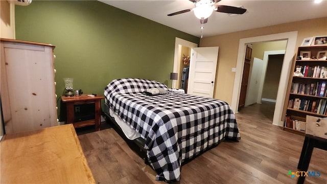 bedroom featuring ceiling fan and wood-type flooring