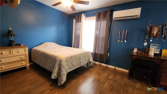 bedroom featuring dark hardwood / wood-style flooring, a wall mounted AC, and ceiling fan