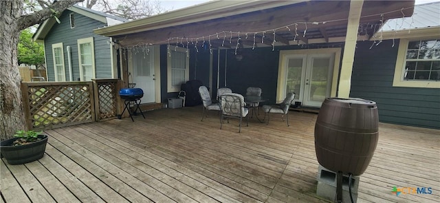 deck featuring french doors and a grill