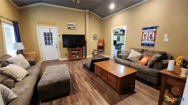 living room featuring ornamental molding, hardwood / wood-style flooring, and lofted ceiling