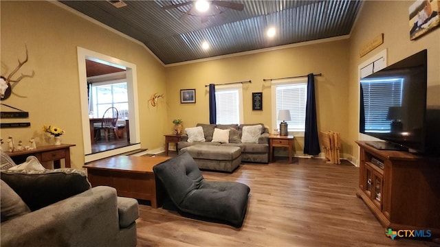 living room featuring ceiling fan, wood-type flooring, and ornamental molding