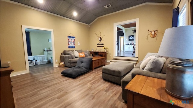 living area with hardwood / wood-style flooring, lofted ceiling, and crown molding