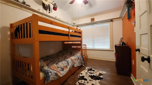 bedroom with ceiling fan, dark wood-type flooring, and lofted ceiling