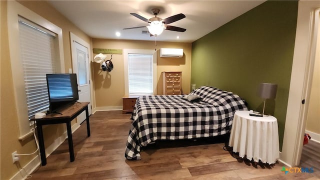 bedroom with hardwood / wood-style floors, ceiling fan, a wall mounted air conditioner, and a closet