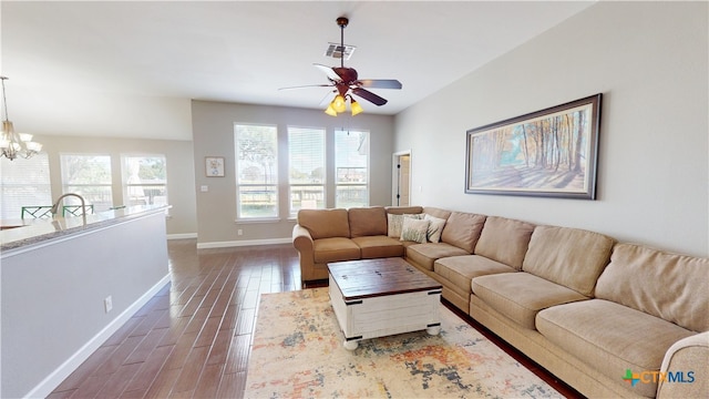 101 Arabian Dr, Victoria, TX 77904 - living area featuring dark wood-style floors, ceiling fan, and a chandelier