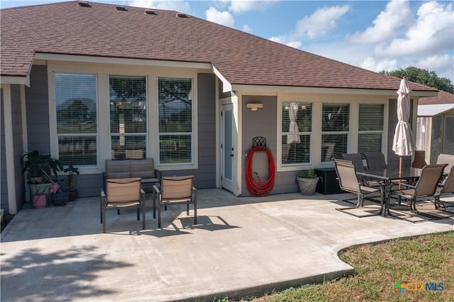 101 Arabian Dr, Victoria, TX 77904 - back of property featuring a patio area, a shingled roof, and outdoor dining area
