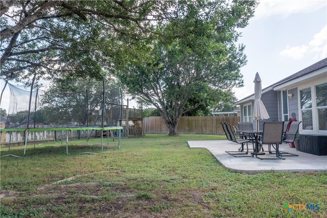 101 Arabian Dr, Victoria, TX 77904 - fenced backyard with a trampoline and a patio