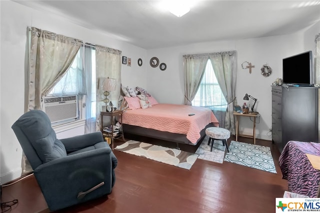 bedroom with cooling unit and hardwood / wood-style flooring