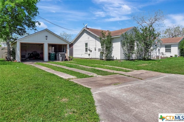 1005 Macarthur St, Victoria, TX 77901 - ranch-style home with a detached garage, an outdoor structure, and a front yard