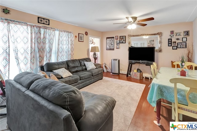 living room featuring hardwood / wood-style flooring and ceiling fan