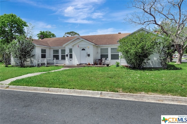 ranch-style house with a front lawn