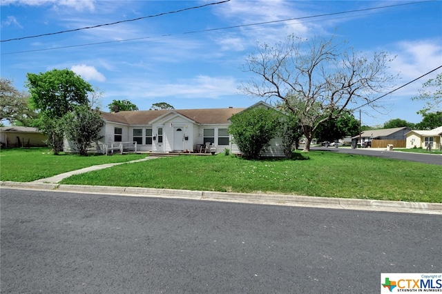 ranch-style house with a front lawn