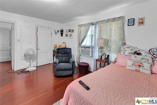 bedroom with hardwood / wood-style flooring and cooling unit